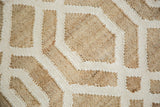 Modern geometric pattern detail of the Nya rug with textured tan jute and cream viscose.