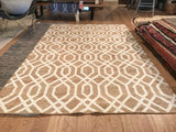 Corner close-up of the handwoven Nya rug, with tan and cream geometric pattern.