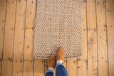Chunky hand-woven texture of the natural beige Saratoga Jute rug mat.