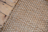 Chunky, hand-woven jute texture of the Saratoga rug, showing natural beige fibers.