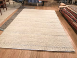 Chunky looped undyed wool texture and neatly finished edge of the Snow New Carpet.