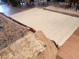 Chunky undyed wool texture of the Snow rug with a charcoal border.