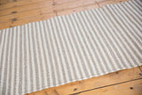 Hand-woven grey and ivory wool rug with textured stripes.