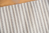 Terra Wool rug's hand-woven texture with alternating gray and white braided stripes.
