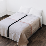 Louise Gray Queen Quilt No. 2 featuring a black and rose cross design on flax ivory.