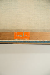 Close-up of orange Tom Tru maker's label, Lambertville, New Jersey on vintage panel.