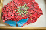 Detail of Maria Jarreau Heller 3D art: vibrant red petals and bright blue butterfly.