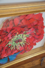 Detail of Maria Heller's hand-painted dark pink flower with intricate green center.