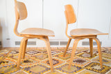 Lower view of natural light wood bentwood legs on a vintage side chair.