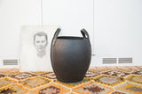 Textured black recycled rubber basket with durable handles and white stitching details.