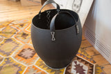 Textured black recycled rubber basket showing white base stitching and side handle detail.