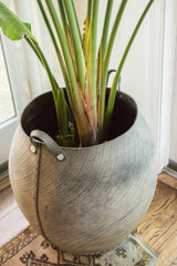 Detail of oversized recycled rubber basket showing tire tread and stitched seam.