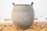 Recycled rubber basket showing bottom stitching and worn tire tread texture.