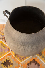 Recycled rubber basket's textured exterior with visible tire tread and dark handle.
