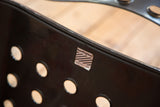 Bieffeplast label on perforated black lacquered metal detail of the vintage Omstak chair.