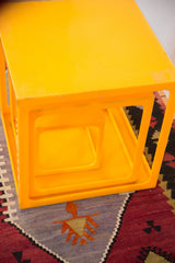Retro tangerine orange nesting cube, showing surface markings and vintage wear.