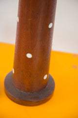 Teak wood lamp stem with white circular pearlescent inlays.