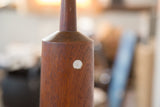 Martz lamp's dark teak wood showing distinct grain and round pearly inlay.