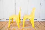 Pair of bright yellow vintage Borg Wagner plastic chairs, side profile.