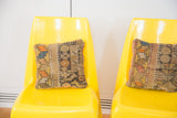 Pair of bright yellow Borg Wagner chairs with vintage geometric pillows.