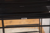 Detail of black spaghetti strands on a vintage Flyline barstool, showcasing the brand label.