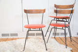 Vintage 1950s Clifford Pascoe chairs with orange vinyl, black iron, and Birchwood, 28 inches tall.