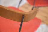 Birchwood backrest and black iron leg attachment of a Mid Century Modern Pascoe chair.