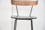Vintage Clifford Pascoe barstool's curved wooden backrest and glossy black vinyl seat.