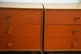 Burnt orange fronts and original worn cupcake pulls on vintage Nelson dressers.