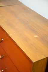 Detail of the George Nelson dresser's wooden top, showing scuffs and a light spot.