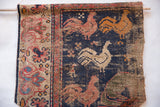 Antique West Persian rug fragment: dark blue field with unique rooster motifs and geometric border.