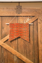 Antique Mir Serbend Persian rug wall hanging displayed as rustic home decor.
