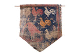 Antique West Persian rug fragment flag with pictorial roosters on a distressed navy blue ground.