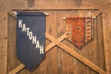 Navy blue fabric banner with white diagonal Katonah text and wooden dowel.