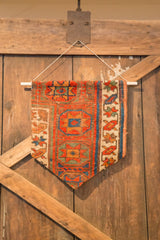 Pointed lower right of the Rugling, showing antique Kurdish rust and blue geometric pattern.