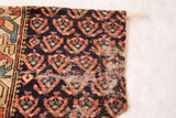 Circa 1880s Northwest Persian rug fragment upper section: dark field, burnt orange motifs, wood dowel.