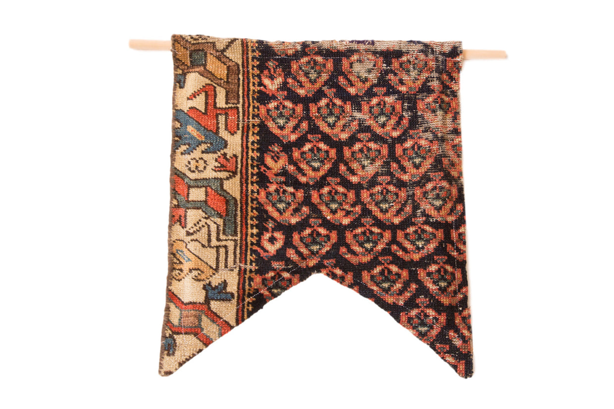 RUGLING 06 antique Northwest Persian rug fragment flag with coral, indigo, and geometric patterns.