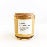 Sweet Clementine soy candle with orange wax in recycled glass jar, cork lid.