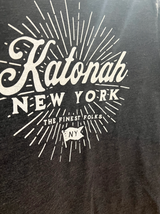 Close-up of the white retro-style graphic on the charcoal Katonah NY t-shirt.