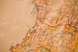 Close-up of antique canvas map detail, showing Louisiana coastline with warm, aged tones.
