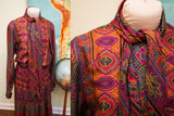Vintage Oscar de la Renta 70s dress with vibrant psychedelic pattern, tie neck, and pleats.