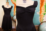 Vintage 80s Betsey Johnson black dress with ruched sweetheart neckline, cap sleeves, and A-line skirt.