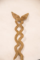 Detail of the vintage bronze snake sculpture, highlighting its wavy, intertwined body.