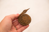 Vintage coiled iron snake sculpture showing its aged, rusty texture.