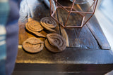 Close-up showing rustic texture of multiple dark iron coiled snake sculptures.