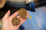 Pair of vintage coiled iron snake figures with distinct rust patinas.