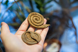 Two unique coiled iron snake sculptures with aged patina.