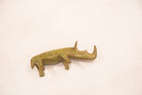 Vintage bronze rhinoceros sculpture with a green patina, viewed from an angled perspective.