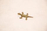 Vintage bronze lizard gold weight with a rustic handmade texture and light green patina.
