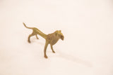 Profile view of a vintage male lion bronze weight, showing the textured mane and slender body.